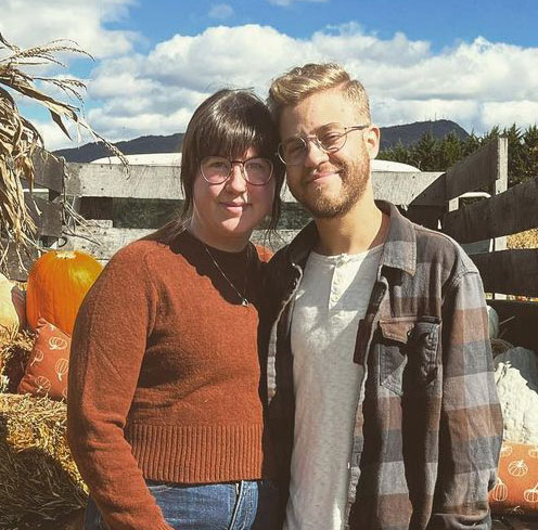 Randall standing in front of pickup truck with pumpkins